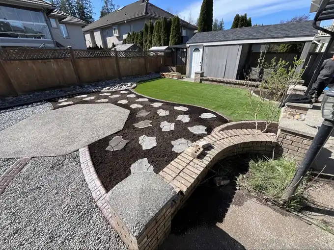 Stone steppers, curved brick edging and a brick pillar built by Top Gun Landscaping