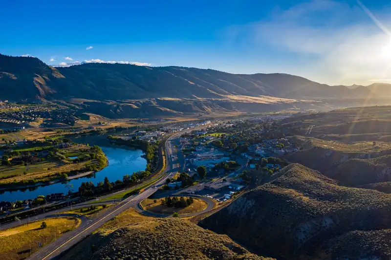 Aerial view of Kamloops, BC at sunset — the Thompson River, highways and dry hills